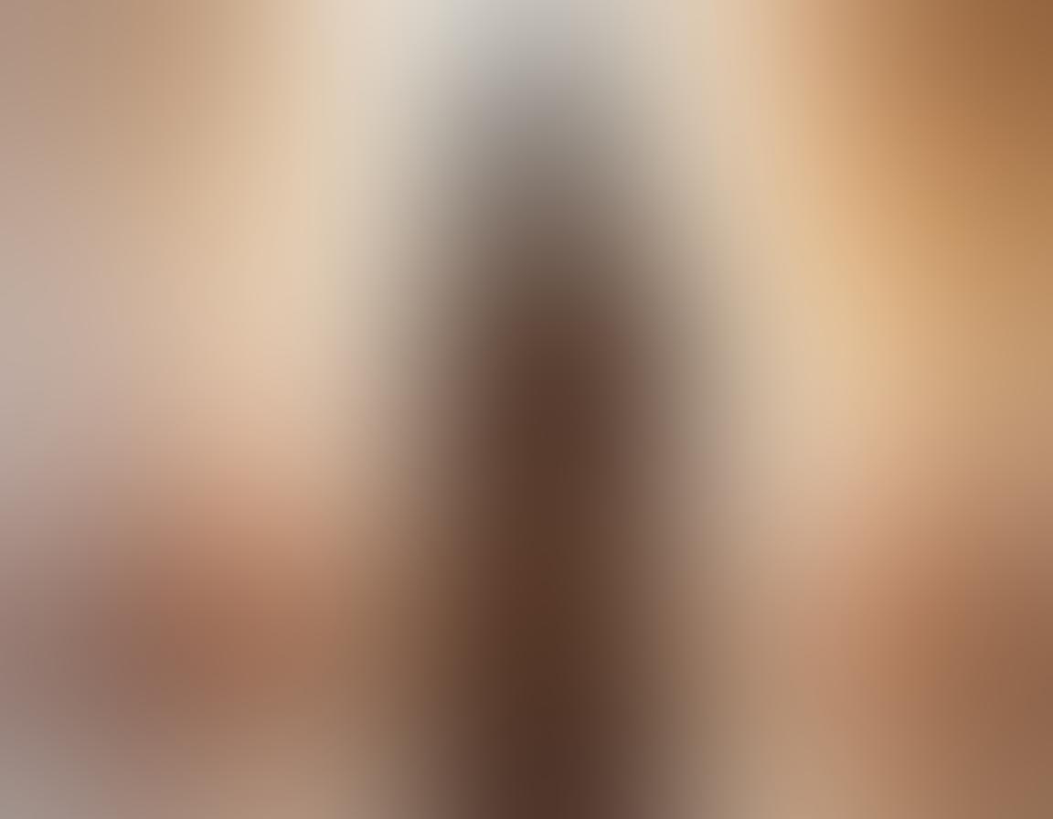 A serene and intimate scene featuring an artistic nude silhouette against a softly lit background, surrounded by gentle textures such as silk and petals. The atmosphere should evoke a sense of vulnerability and elegance, with warm tones casting a soothing glow. Include elements like subtle brush strokes to represent artistry and freedom of expression. Soft shadows playfully dance around the figure, enhancing the sense of intimacy. painting. warm tones. textured background.